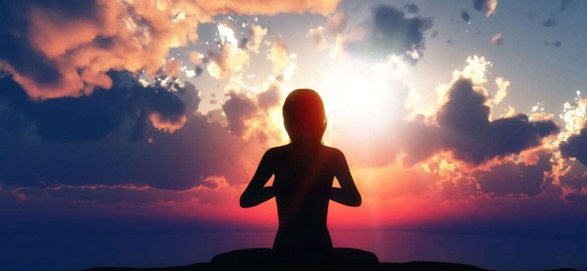 3D female in yoga pose against a sunset sky